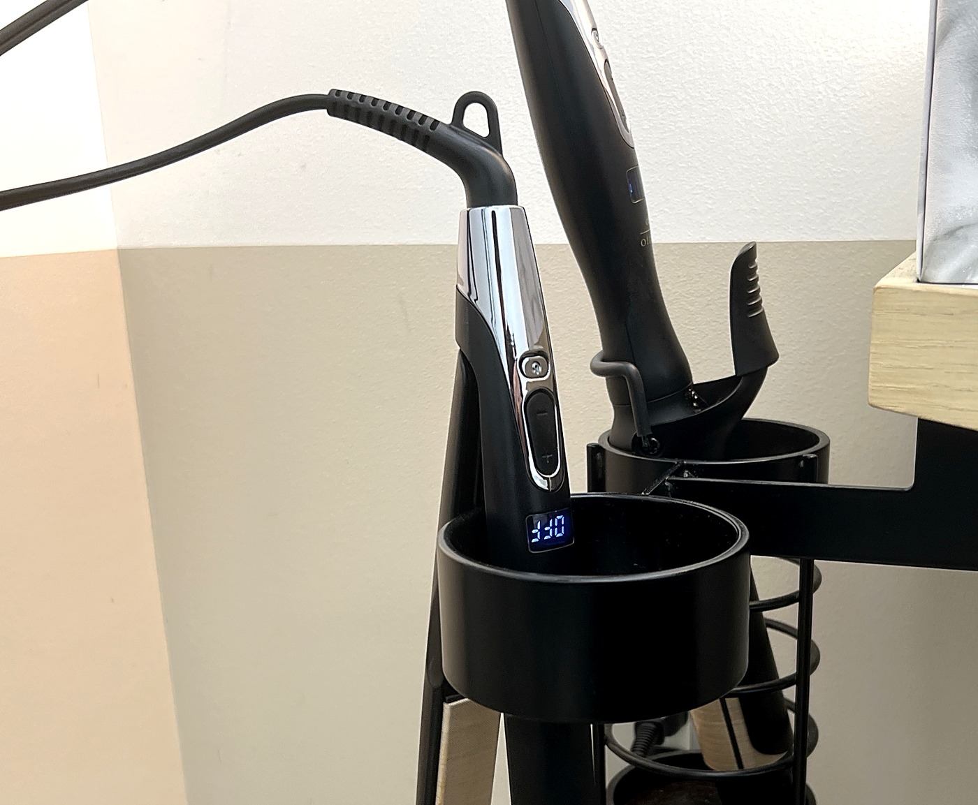 サロンでKINUJO Proのストレートアイロンとコテをホルダーに引っ掛けて収納しているところ